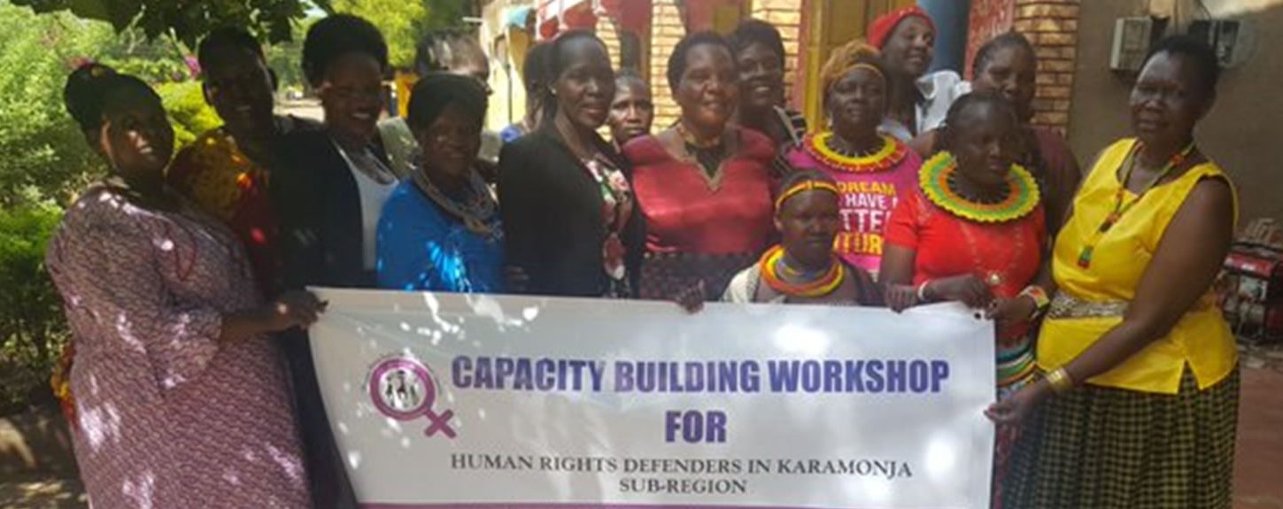 Women defenders in Karamoja Region pose for a photo after a capacity building workshop