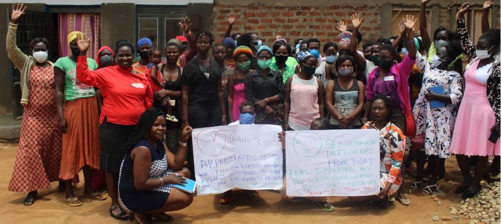 WHRDs of West Nile Regional Network (raising hands) as a symbol of sisterhood
